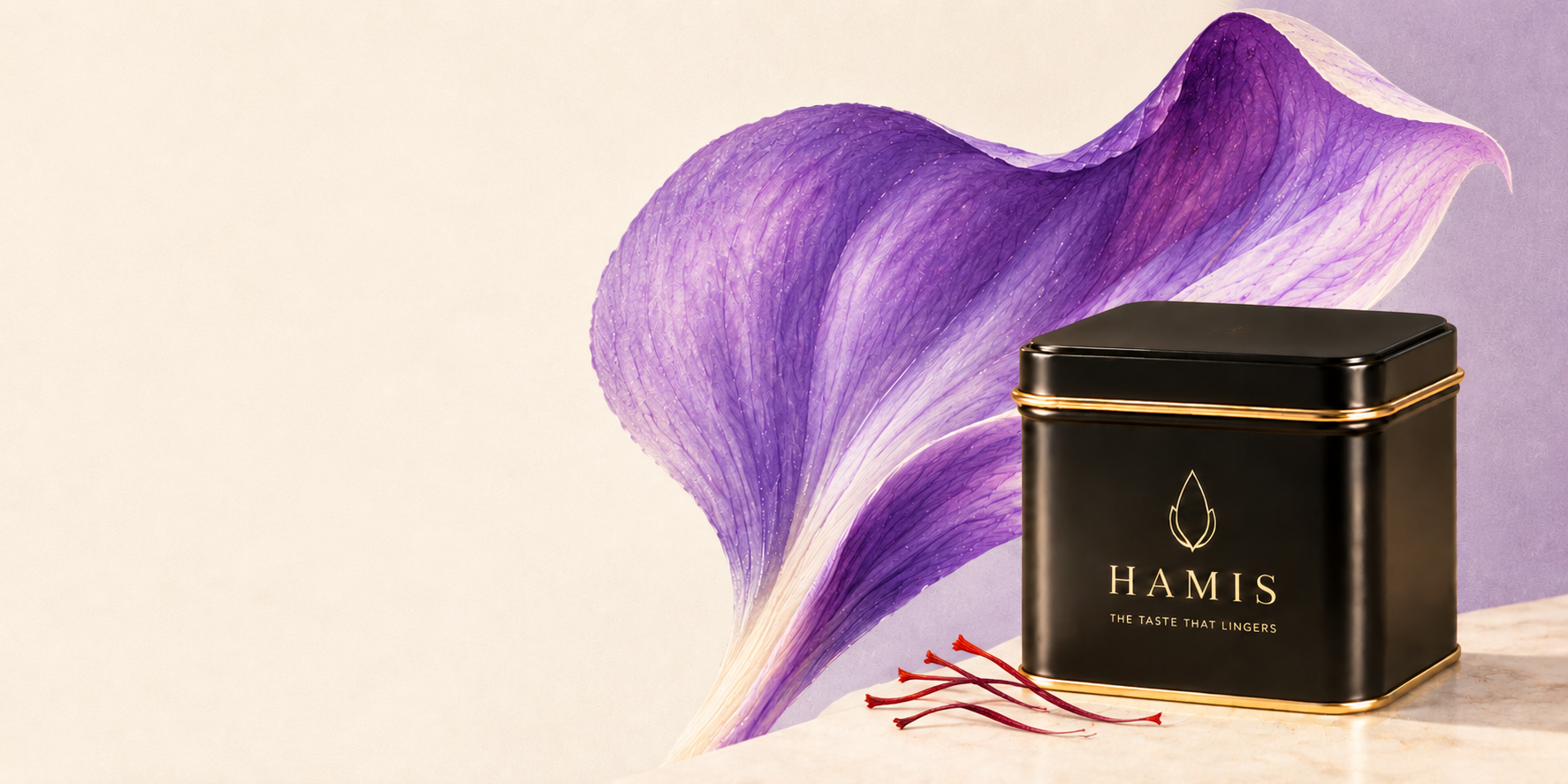Saffron crocus petal beside a black HAMIS tin and a few saffron threads on pale marble